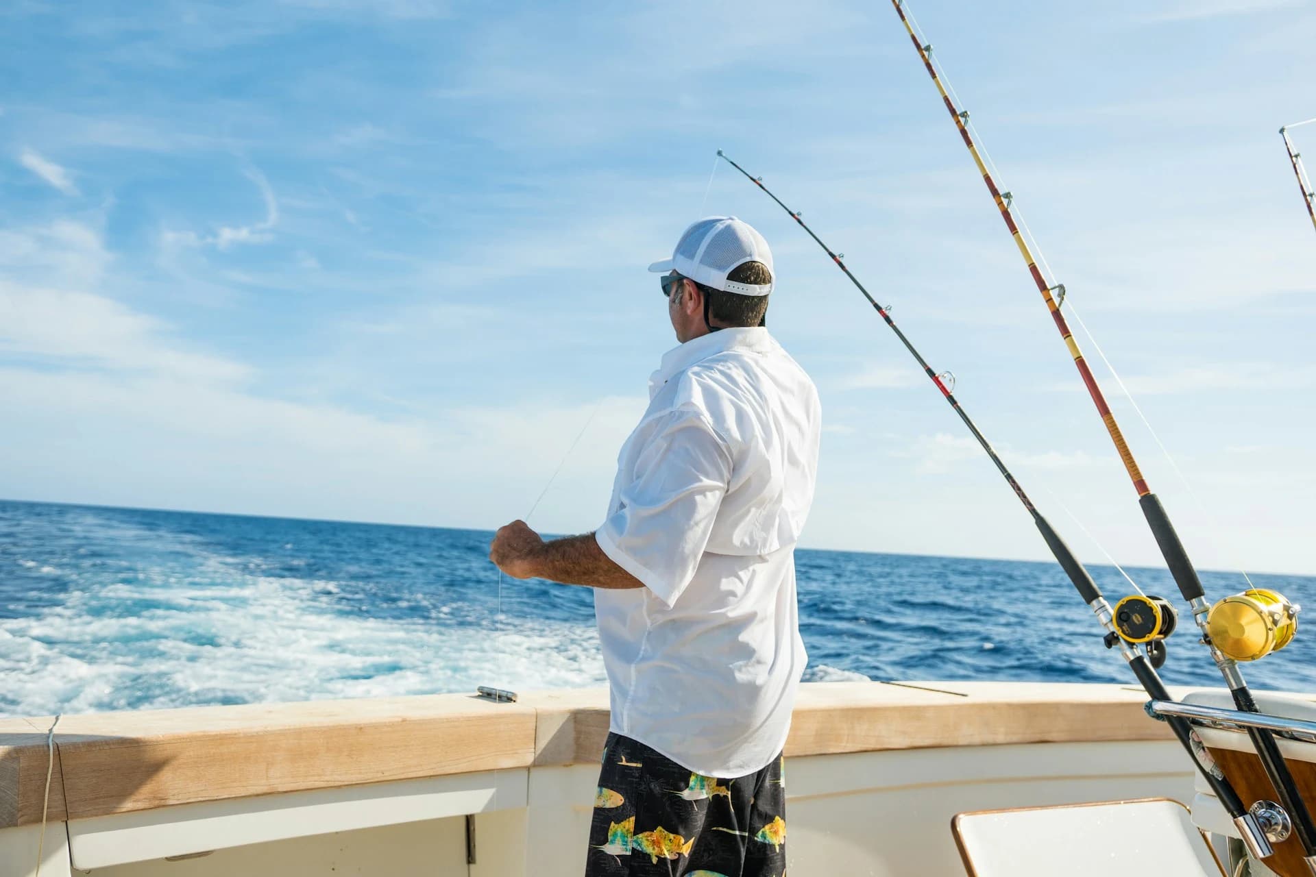 Sportfishing boat on the Sea of Cortez near La Paz, Baja California Sur, with anglers fighting a dorado