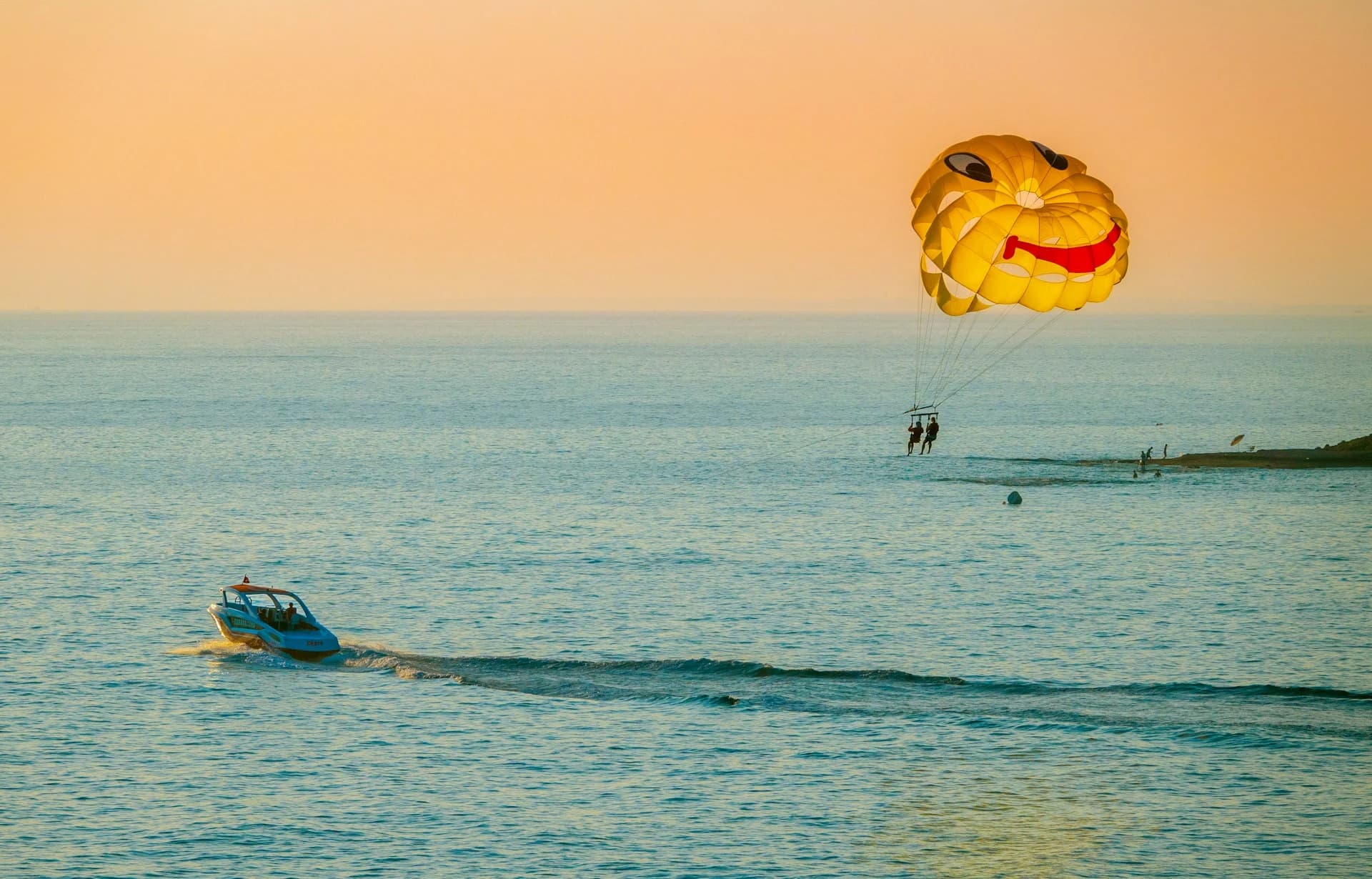 Parasailer high above the turquoise bay of Cabo San Lucas with El Arco and Land's End in the background