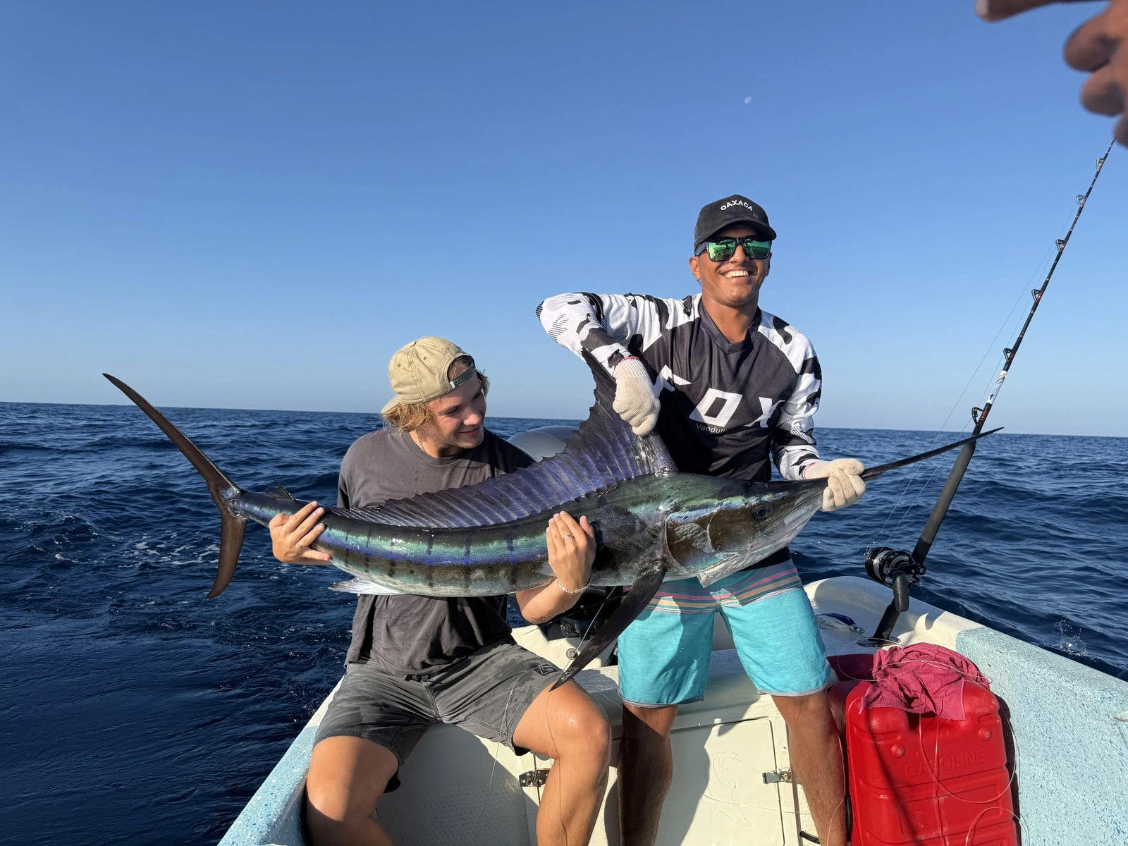 Anglers holding a marlin and sailfish catch on a fishing charter in La Paz, Baja California Sur, Mexico